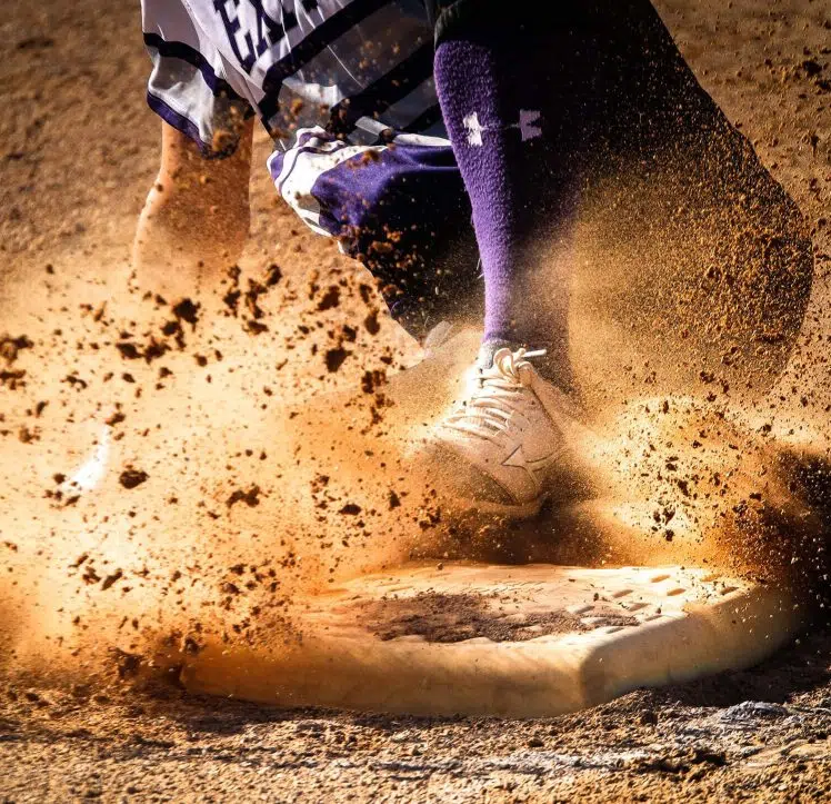 Baseball player sliding into base