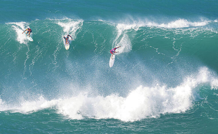 ERIK KABIK / SPECIAL TO THE STAR-ADVERTISER
                                At top, Landon McNamara, right, jumped on a wave with two other surfers at Sunday at the Eddie Aikau Big Wave Invitational at Waimea Bay.