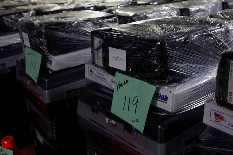 REUTERS/SHANNON STAPLETON/FILE PHOTO
Wrapped voting machines wait for delivery inside the Allegheny County Elections Warehouse in Pittsburgh, Penn., on Wednesday.