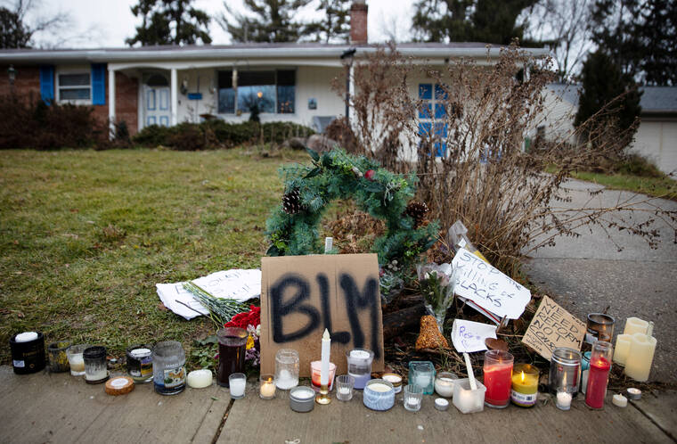 REUTERS/MEGAN JELINGER/FILE PHOTO
                                Candles burn outside the home where Andre Maurice Hill, 47, was killed in Columbus, Ohio, in December 2020. A former Ohio police officer was convicted of murder by a jury today for fatally shooting Andre Hill, an unarmed Black man.