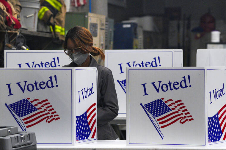 JEENAH MOON / REUTERS
                                A person votes at Engine Company 15 today in Pittsburgh during the 2024 U.S. presidential election.