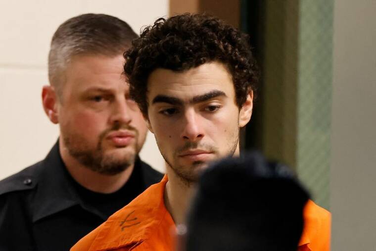 REUTERS/EDUARDO MUNOZ/FILE PHOTO
                                Luigi Mangione, 26, a suspect in the New York City killing of UnitedHealth executive Brian Thompson, is escorted after an extradition hearing at Blair County Court House in Hollidaysburg, Penn., on Tuesday.