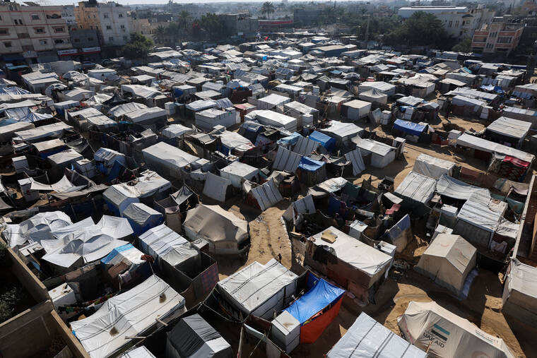 REUTERS/RAMADAN ABED
                                Displaced Palestinians shelter at a tent camp, amid the Israel-Hamas conflict, in Deir Al-Balah in the central Gaza Strip.