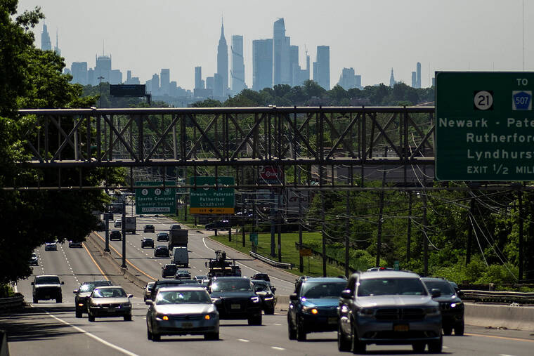 REUTERS/EDUARDO MUNOZ / MAY 24
                                Cars drive along a highway during the Memorial Day weekend while the New York Skyline and the Empire State Building are seen in the background in Clifton, New Jersey.