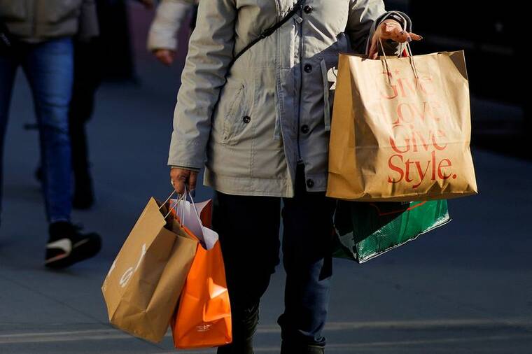 REUTERS/EDUARDO MUNOZ/FILE PHOTO
                                A woman carries shopping bags during the holiday season in New York City, in December 2022.