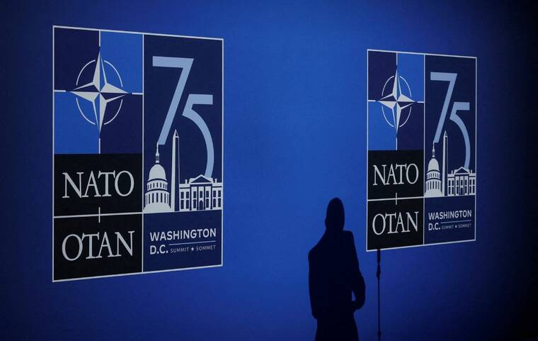 REUTERS/YVES HERMAN/FILE PHOTO
                                A journalist casts a shadow next to logos on the day of the NATO 75th Anniversary celebratory event in Washington, on July 9. A high-level delegation from South Korea will brief the North Atlantic Council about North Korea’s troop deployment to Russia on Monday, NATO said on Sunday, after the U.S. expressed grave concern over the possible use of the troops against Ukraine.