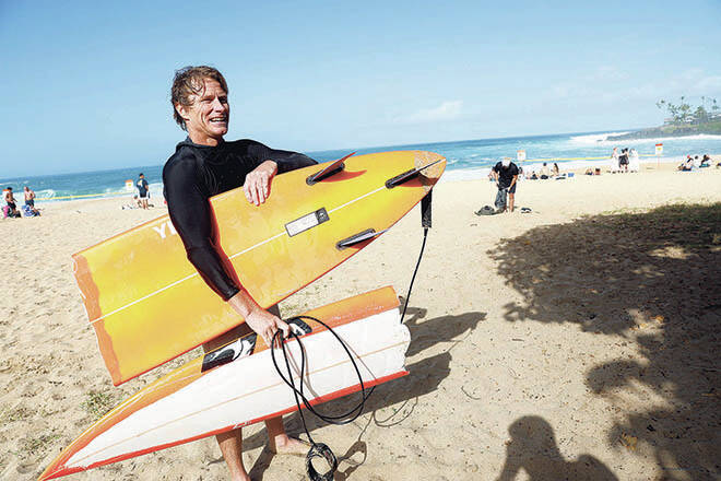 JAMM AQUINO / JAQUINO@STARADVERTISER.COM
                                Professional surfer Mark Healey comes ashore with a broken board while surfing Waimea Bay on Friday.