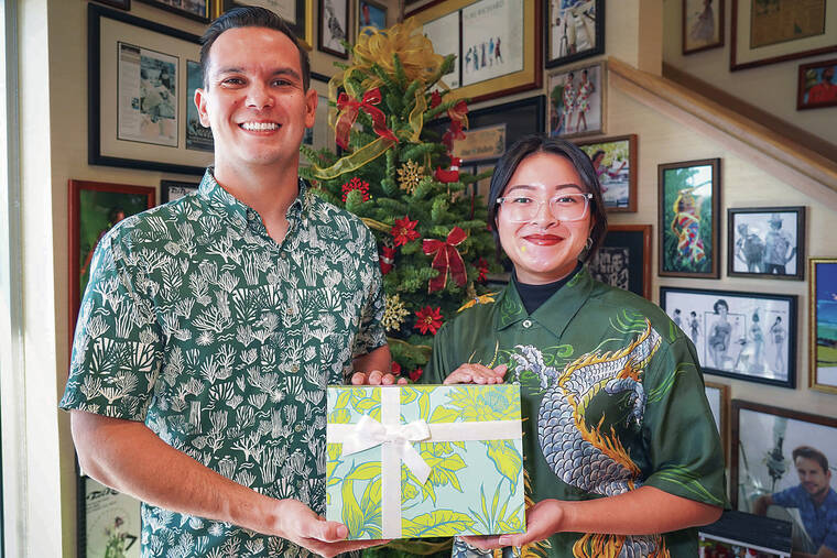 MICHELLE BIR / SPECIAL TO THE STAR-ADVERTISER
                                Nainoa Fiddler and Jayla Kaita of Honolulu-based clothing company Tori Richard participate every year in the Adopt-a-Family program, donating gifts to families in need.