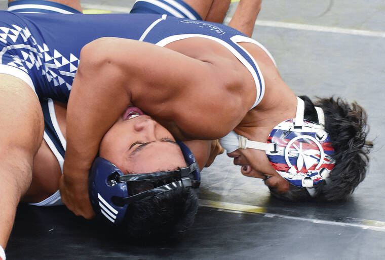 JERRY CAMPANY /JCAMPANY@STARADVERTISER.COM
                                Mikah Labuanan of Kamehameha-Maui has a wrestler in a predicament Friday at the Officials Scholarship Tournament at Leilehua.