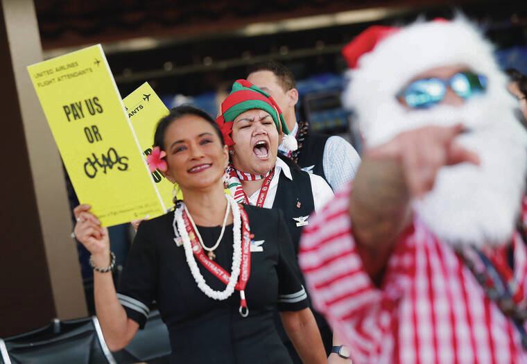 JAMM AQUINO / JAQUINO@STARADVERTISER.COM
                                United Airlines flight attendants Kaimi Mohika, front, Sandi Siple, left, and Genelle Jucutan-Puga picketed Thursday with fellow flight attendants as travelers passed at Daniel K. Inouye International Airport.