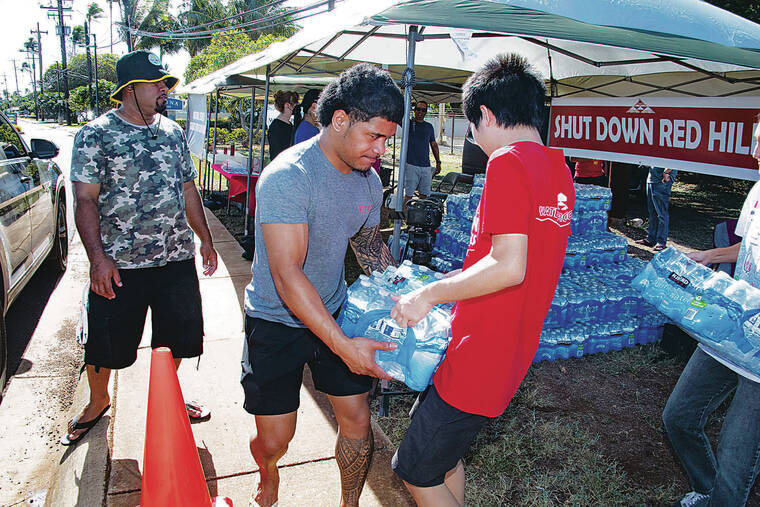 CRAIG T. KOJIMA / CKOJIMA@STARADVERTISER.COM
                                Activists and volunteers handed out water in November 2022, a year into the Red Hill water crisis when jet fuel from the Navy’s storage facility tainted the area’s water system.