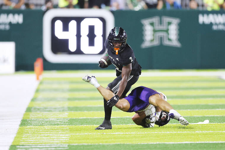 MARCO GARCIA / SPECIAL TO THE HONOLULU STAR-ADVERTISER
                                Hawaii Rainbow Warriors wide receiver Nick Cenacle gets over Northern Iowa Panthers linebacker Tyson Cooreman during the third quarter of a game on Sept. 21.