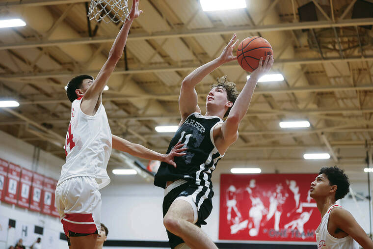 GEORGE F. LEE / GLEE@STARADVERTISER.COM
                                Utah Prep Jackson Rasmussen goes to the hoop against Kahuku Red Raiders Ronin Naihe during an Iolani Classic Boys basketball game Wednesday at Iolani Gym.